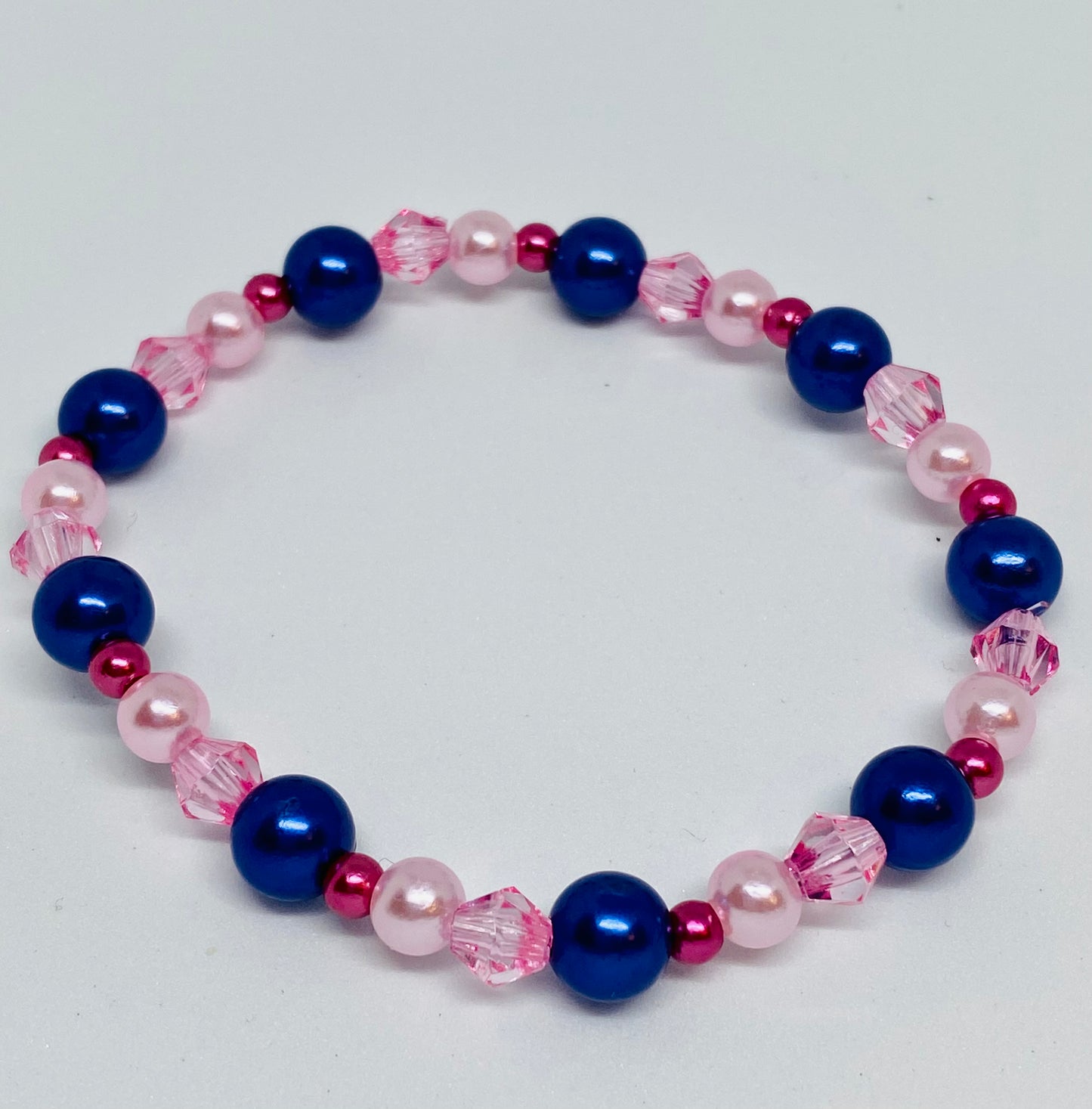 7" beaded flexible bracelet blue, and 3 pink shades