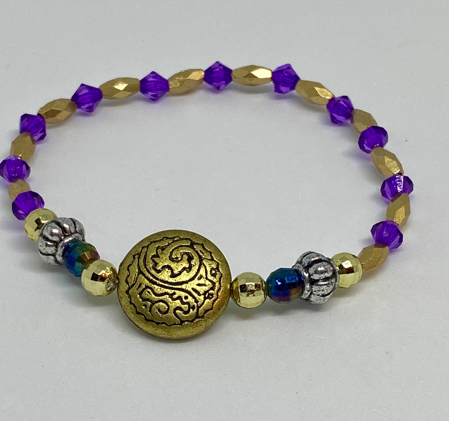 7.5" beaded flexible bracelet gold. Silver, purple